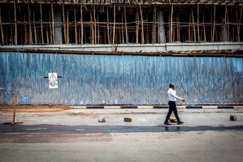 RWA RWANDA RUANDA Kigali A man passes a construction site in the Kiyovu banking district