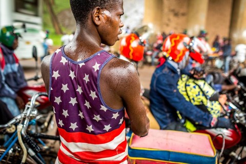 RWA RWANDA RUANDA Kigali Taxi drivers with motorbikes and bicycles wait under a bridge for the end