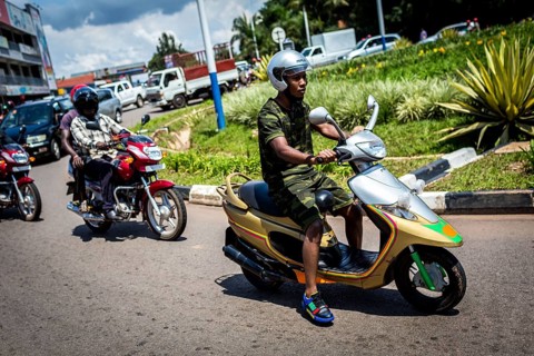 RWA RWANDA RUANDA Kigali A youth in camouflage fashion on a scooter