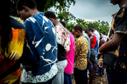 RWA RWANDA RUANDA Kigali A youth group stands in front of a mass grave at the genocide memorial