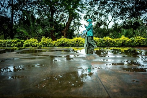 RWA RWANDA RUANDA Kigali A visitor plays in the puddles of water on a mass grave at the genocide