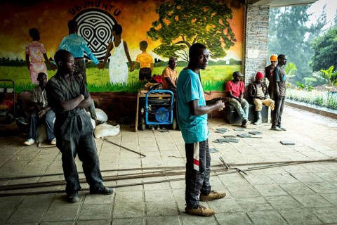 RWA RWANDA RUANDA Kigali workers take a break due to rain showers. They are renovating the