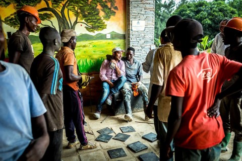 RWA RWANDA RUANDA Kigali workers take a break due to rain showers. They are renovating the