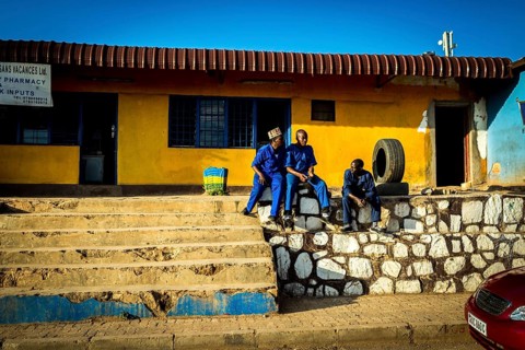 RWA RWANDA RUANDA Kigali Tyre mechanics wait for customers in front of their workshop