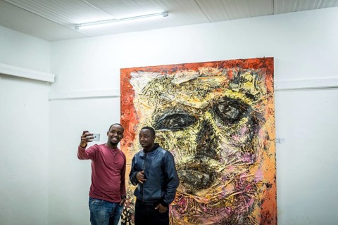 RWA RWANDA RUANDA Kigali Guests take a selfie at a regular party at the Inema Gallery. Artists,