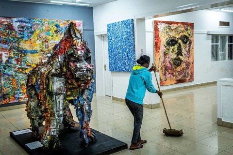 RWA RWANDA RUANDA Kigali A cleaning lady mops during the party at the Inema Gallery. Artists,