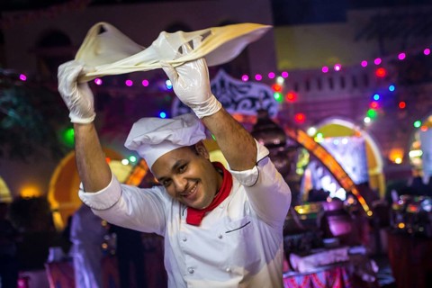 Egypt Hurghada A baker turns his bread dough in the air during an evening promotional event for