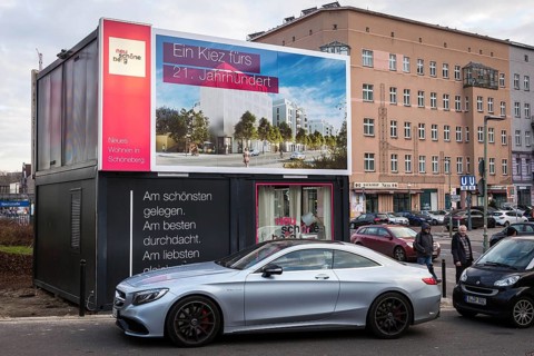 DEU Germany Germany Berlin A luxury car parked in front of a presentation container for new