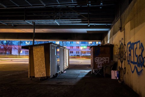DEU Germany Germany Berlin Wooden shacks financed by donations stand under the motorway bridge in