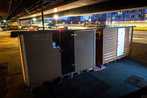 DEU Germany Germany Berlin Wooden shacks financed by donations stand under the motorway bridge in