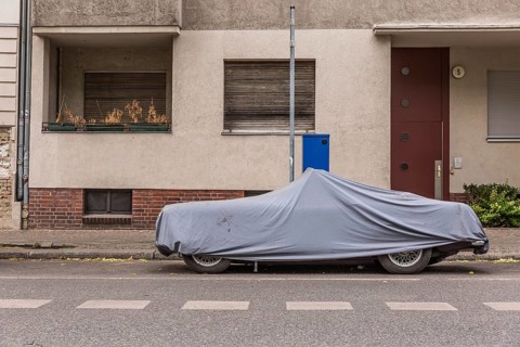 DEU Germany Germany Berlin A covered car stands in front of a parking ticket machine in