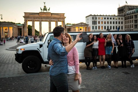 DEU Germany Germany Berlin Young woman pose with a rented stretch limousine in front of the
