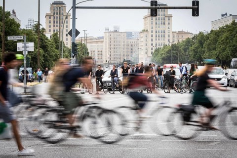 DEU Germany Germany Berlin Scene with cyclists in traffic in the capital Karl-Marx-Alle, corner of