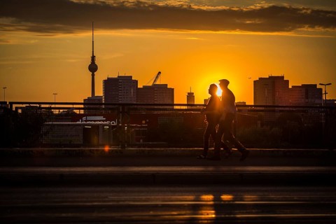 DEU Germany Germany Berlin Cyclists and pedestrians at sunset on the Warsaw Bridge