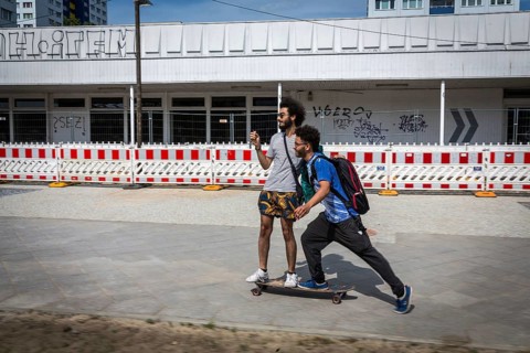 DEU Germany Germany Berlin Two friends move through Berlin on a skateboard