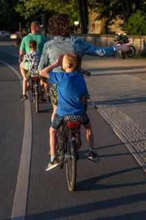DEU Germany Germany Berlin Parents with their children on the pannier rack during a bike tour