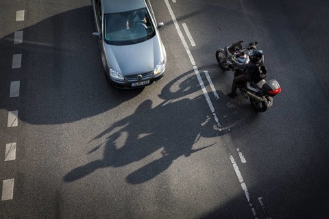 DEU Germany Germany Berlin Scene with motorcyclist on Schlossstraße in Steglitz Motorcyclist turns