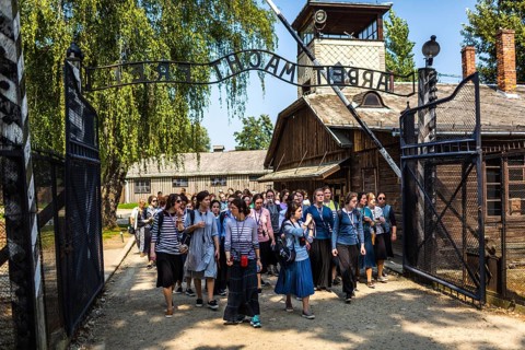 POL Poland Poland Auschwitz group of visitors at the entrance to the memorial site of the former