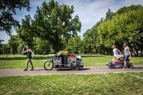 DEU Germany Germany Berlin Young men transporting technology for an event through Volkspark