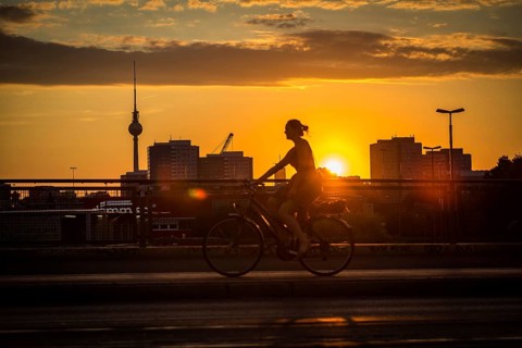 DEU Germany Germany Berlin Cyclists and pedestrians at sunset on the Warsaw Bridge