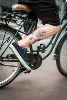 DEU Germany Germany Berlin A skull tattoo on a cyclist's leg
