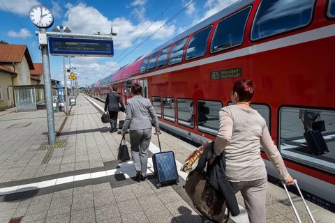 DEU Germany Germany Neubrandenburg Passengers with wheeled suitcases in front of boarding a