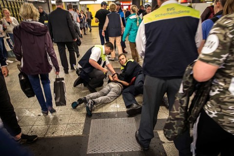 DEU Germany Germany Berlin BVG security staff hold a man on the ground in the subway at Zoo station