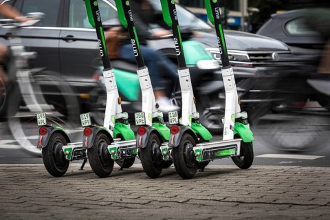 DEU Germany Germany Berlin Traffic passes parked e-scooters on Karl-Liebknecht-Str