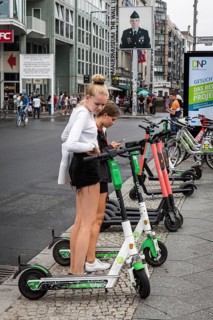 DEU Germany Germany Berlin Tourists with e-scooters at Checkpoint Charlie