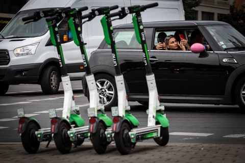 DEU Germany Germany Berlin Traffic passes parked e-scooters on Karl-Liebknecht-Str