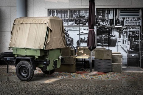 DEU Germany Germany Berlin Ammunition boxes and a military trailer in front of a photo from the