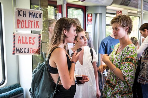 DEU Germany Germany Berlin Students discuss the G20 summit on the Berlin S-Bahn. A loose group of
