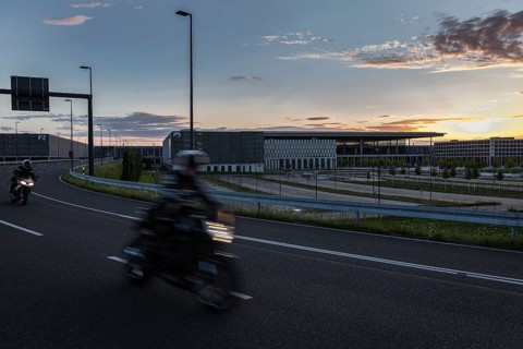 DEU Germany Germany Berlin Motorbikes pass the future BER Berlin-Brandenburg airport at sunset