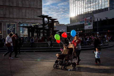 DEU Germany Germany Berlin People in the light at Alexanderplatz