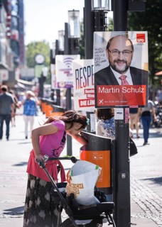 DEU Germany Germany Berlin A woman searches for recyclables in the rubbish bin in front of election