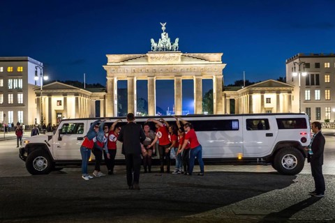 DEU Germany Germany Berlin Bride with friends posing in front of stretch limousine in front of the