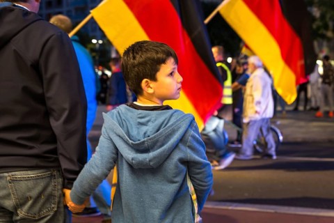 DEU Germany Germany Dresden Pegida demonstration in the city centre. Father and son trying to cross