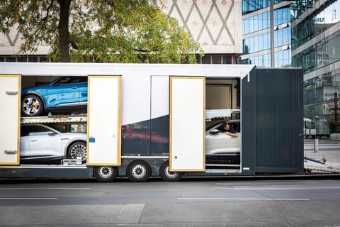 DEU Germany Germany Berlin SUVs with electric motors are loaded onto a transporter in Kantstrasse.