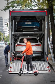 DEU Germany Germany Berlin SUVs with electric motors are loaded onto a transporter in Kantstrasse.