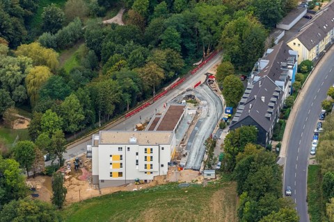 Aerial view, construction site, new multi-family house with day care centre,
