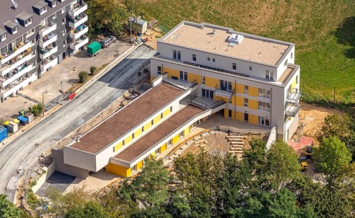 Aerial view, construction site, new multi-family house with day care centre,