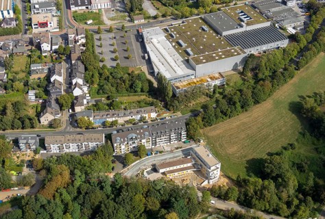 Aerial view, construction site, new multi-family house with day care centre,