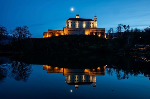 Moon over Trautenfels Castle, reflection in a lake, blue hour, near Irdning, Ennstal, Styria,