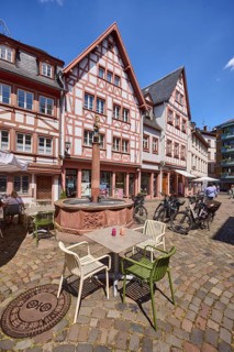Marienbrunnen, stone fountain, historic half-timbered houses, buildings, bicycles, square made of