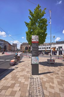 Stele with location sign, traffic area, street, square, sidewalk made of concrete paving stones,
