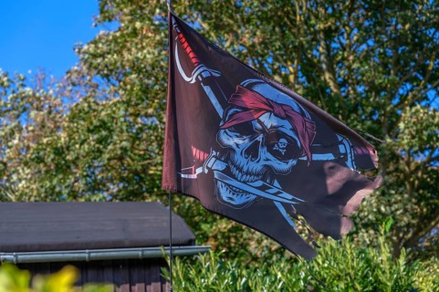 Pirate flag in a garden, Ahrenshoop, Darß, Mecklenburg-Western Pomerania, Germany