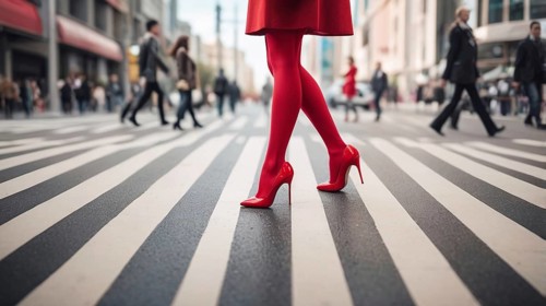Woman in striking red tights and heels striding across a striped city crosswalk, AI generated