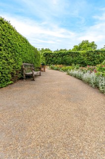 Gravel walking path winding through the formal and carefully manicured gardens of Hyde Park