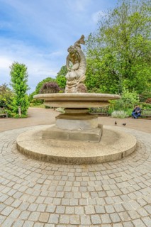 London, United Kingdom - 15 May 2025: Classic stone sculpture of a sea creature in the tranquil