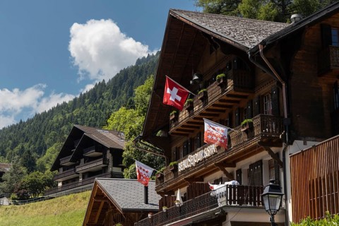 Chalets with a Swiss flag are pictured in Champery, a village in the mountains by the French border